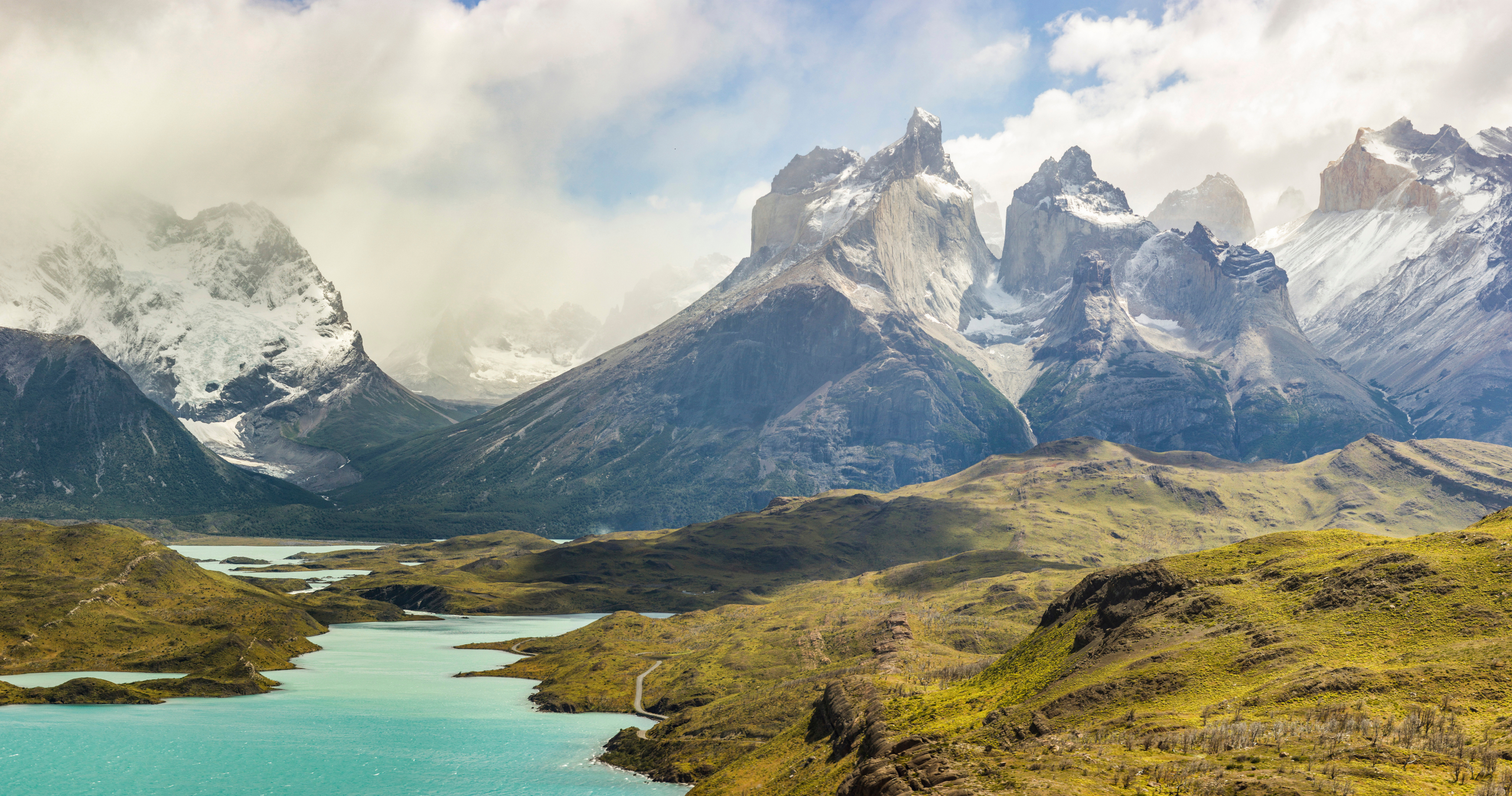 mountains of patagonia in haze at sunrise near blue lake
